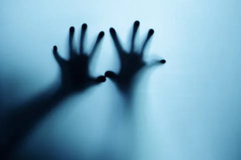 Shadow of a zombie hand on white background. Stock Photos