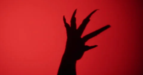Shadow of a zombie's hand in red scene. Stock Footage 276814010