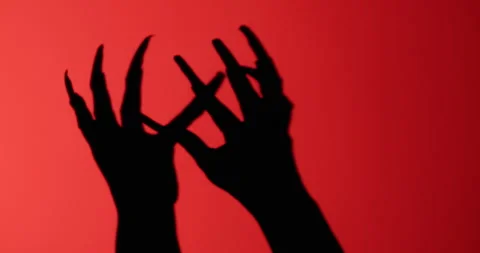 Shadow of a zombie's hand in red scene. Stock Footage 278089982