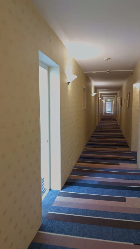 Shadowed corridor with dramatic perspective. Unnerving hotel hall with deep Video stock 333908592