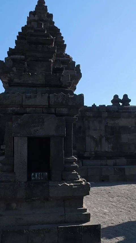 Shadowed stone courtyard and gateway reveal historic shrines within the sac.. Stock Footage 341543218