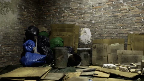 Shadowed underground space filled with clutter and peeling paint textures Stock-Footage 335596199