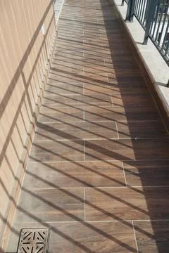 Shadows and patterns on a balcony floor Stock Photos