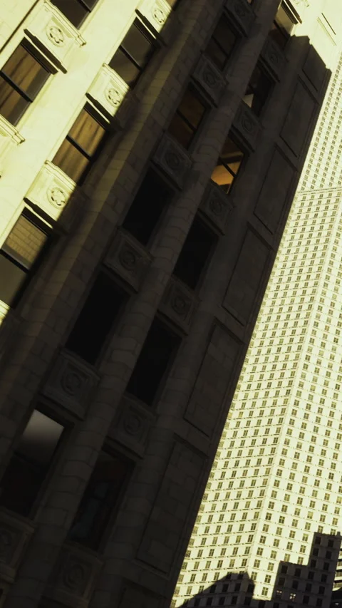 Shadows and reflections dance on tall city buildings during bright daylight Stock Footage 331694567
