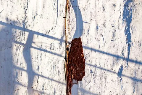 Shadows of bars on whitewashed faade Stock Photos