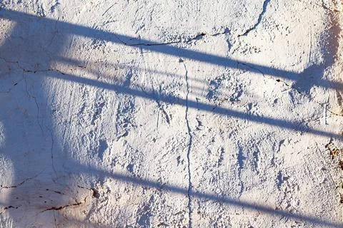 Shadows of bars on whitewashed facade Stock Photos