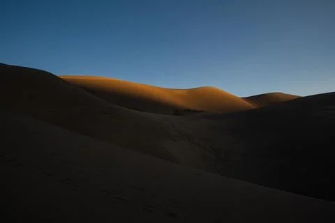 Shadows Begin To Fade Over The Rolling Dunes Of Great Sand Dunes Stock Photos