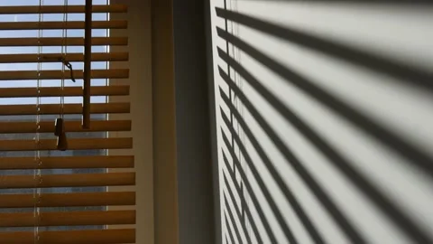 Shadows from the blinds on a white wall. Video stock 210215148