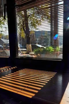 Shadows from the blinds on the windowsill Stock Photos