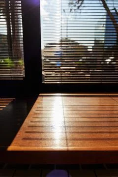 Shadows from the blinds on the windowsill Stock Photos