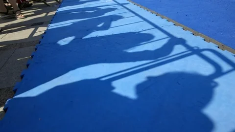 Shadows on blue path for gymnasts Stock-Footage 103945588