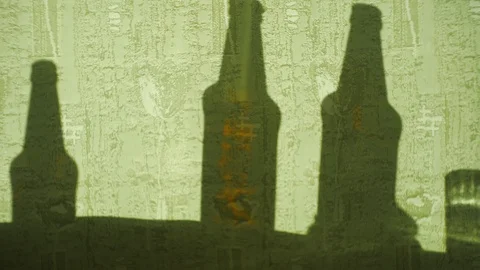 Shadows of bottles on a moving fabric. Stock Footage 114482998