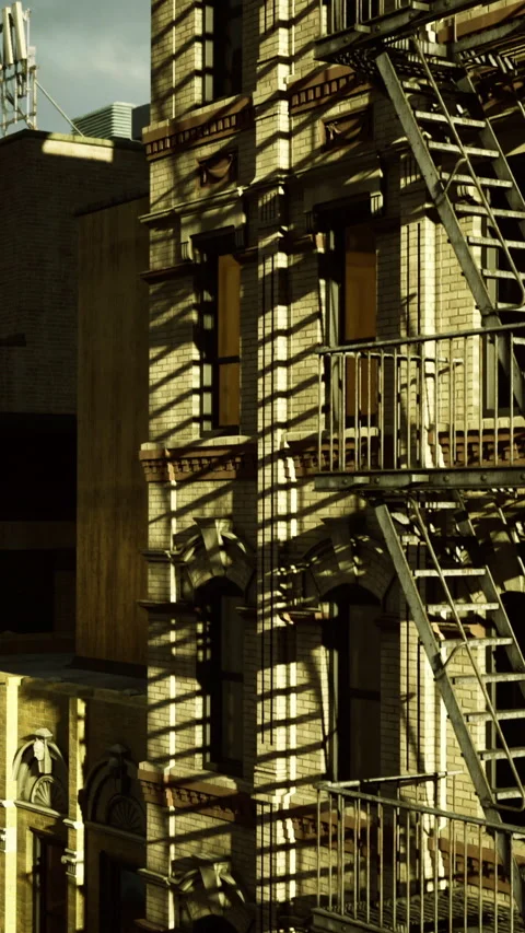 Shadows cast by fire escape on building wall in urban setting during afternoon Stock Footage 335449389