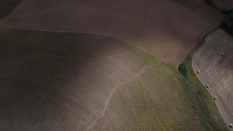 Shadows of clouds on the hay rolls in farm fields in autumn cloudy day Stock Footage 334326193