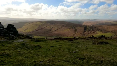 Shadows from clouds pass over the landscape of a stunning Dartmoor Tor Stock Footage 171021651