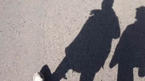 Shadows of a couple walking down the street. Stock Footage 154261767