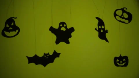 Shadows of creepy characters on yellow background in darkness Video stock 219494995