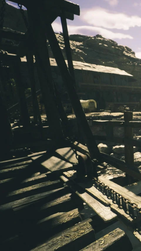 Shadows dance over ancient wood at an abandoned mining site in daylight Stock Footage 331805793