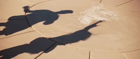 Shadows of dancing people with raised hands on the pavement Stock Footage 315927721
