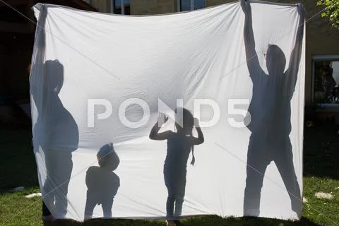 Shadows Of A Family Behind A Sheet -Symbol Of A Family