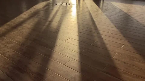 Shadows flood an empty seaside function hall at the beach during sunset. Video stock 260973541