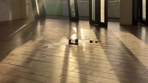 Shadows flood an empty seaside function hall at the beach during sunset. Video stock 260973559