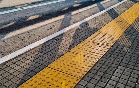 Shadows on the floor at a bus stop. Stock Photos