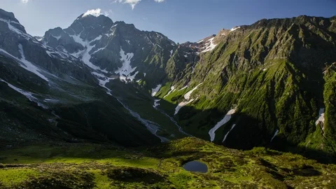 Shadows on the green hill range timelapse. Glacial valley in summer Stock-Footage 88181976