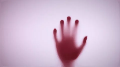 Shadows of the hand hit the door and slowly crawled down. The concept of violenc Stock Footage 224674375