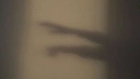 Shadows of hands reaching forward on cement wall Stock Footage 325992125