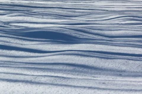 Shadows from the lines on the snow Stock Photos