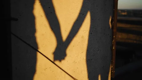 The shadows of lovers on the wall holding hands Stock Footage 151544405