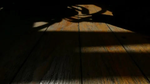 Shadows move along the surface old wooden floor. Time-lapse. Stock Footage 153937544