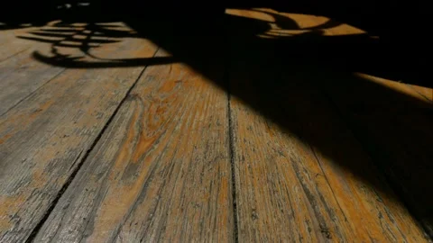 Shadows move along the surface old wooden floor. Time-lapse. Stock Footage 153937567