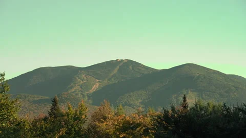 Shadows moving over ski mountain during summer with beautiful fall foliage l Stock Footage 161884889