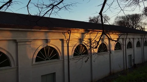 Shadows of moving people in the sunset light on a historical building in Stock-Footage 75230270