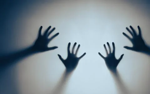 Shadows of Outstretched Hands on a Blue Background Creating Mysterious Mood Stock Photos