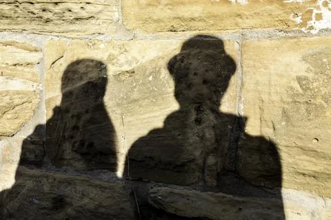 Shadows of a pair of lovers on the big rocks of a medieval castle Stock Photos