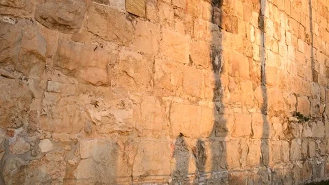 Shadows of people reflected on the wall surrounding the old city of Jerusalem. Stock Footage
