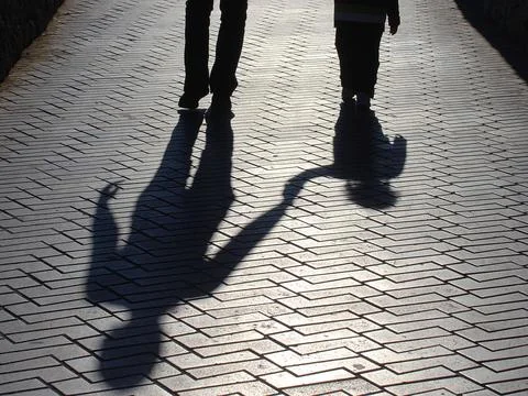 Shadows of people walking Stock Photos