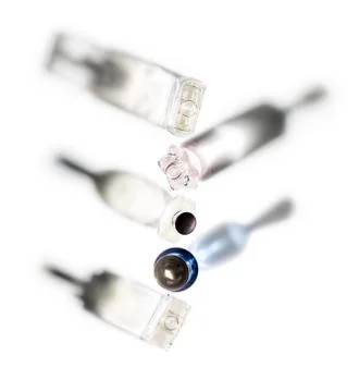 Shadows of perfume bottles directed in different directions on a white Stock Photos