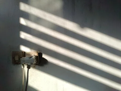 Shadows produced by sunlight coming in through the gaps in the windows. Foto stock