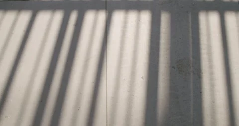 Shadows of Railing on Tiled Floor: Abstract Light and Shadow Pattern 動画素材 318301295
