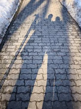 Shadows of two people on stone path Stock Photos