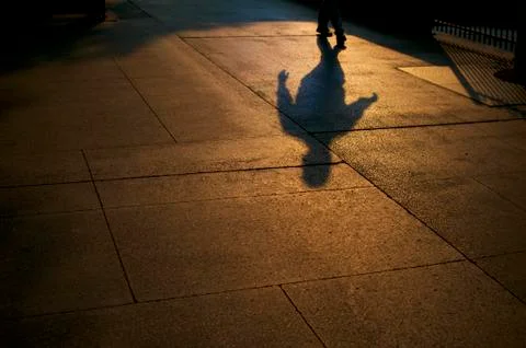 Shadows of walking people Stock Photos