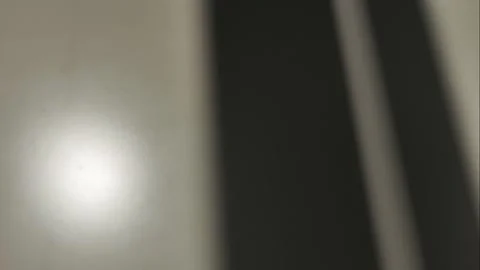 The shadows of the window move against a white background. The light flicker Stock Footage 312252195