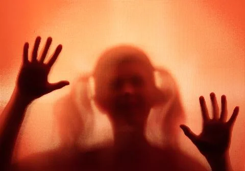 Shadowy figure, child behind glass - horror background Stock Photos