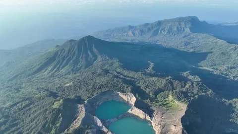 Shadowy forests and volcanic ridges create dramatic patterns across Flores Stock Footage 318835911
