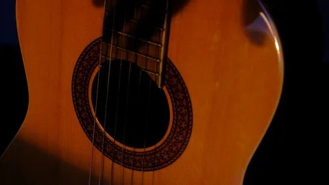 Shadowy Hand Strums Classical Guitar Strings Stock Footage 121583035