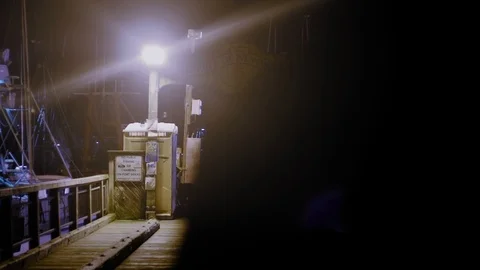 Shadowy man walks down pier at night (Slow Motion) Stock Footage 99597908